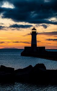 Preview wallpaper stones, lighthouse, silhouette, sea, twilight