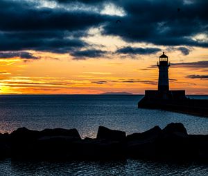 Preview wallpaper stones, lighthouse, silhouette, sea, twilight