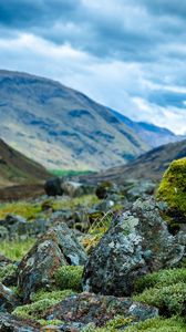 Preview wallpaper stones, moss, mountains, hollow, sky, cloudy