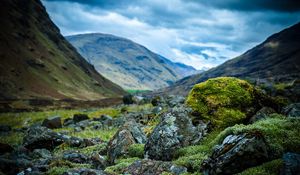 Preview wallpaper stones, moss, mountains, hollow, sky, cloudy