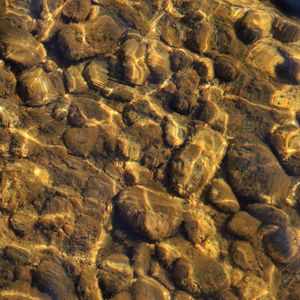 Preview wallpaper stones, pebbles, glare, water, bottom, underwater