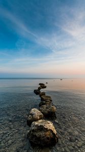 Preview wallpaper stones, pebbles, sea, horizon, sky