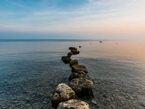 Preview wallpaper stones, pebbles, sea, horizon, sky