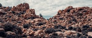 Preview wallpaper stones, rocks, bushes, sky, clouds