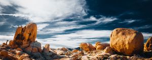 Preview wallpaper stones, rocks, field, clouds, sky, nature