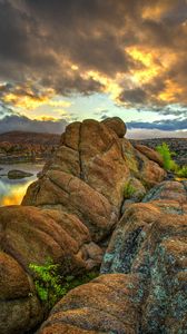 Preview wallpaper stones, rocks, mountains, river, sunset, sky