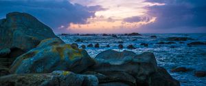 Preview wallpaper stones, rocks, sea, sunset, clouds