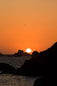 Preview wallpaper stones, rocks, sea, sunset, dark