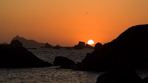 Preview wallpaper stones, rocks, sea, sunset, dark