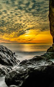 Preview wallpaper stones, rocks, sea, horizon, evening