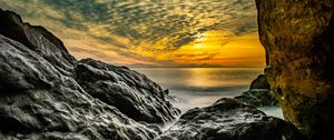 Preview wallpaper stones, rocks, sea, horizon, evening