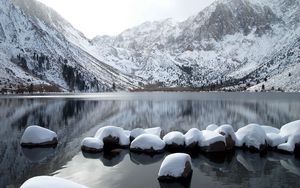 Preview wallpaper stones, row, snow, mountains, lake, distance