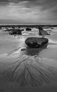 Preview wallpaper stones, sand, sea, bw