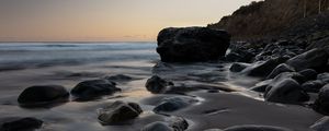 Preview wallpaper stones, sand, water, wet, coast, sea, twilight