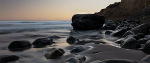 Preview wallpaper stones, sand, water, wet, coast, sea, twilight