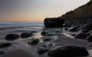 Preview wallpaper stones, sand, water, wet, coast, sea, twilight