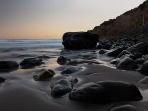 Preview wallpaper stones, sand, water, wet, coast, sea, twilight