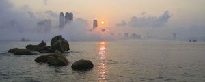 Preview wallpaper stones, sea, fog, city, sunrise