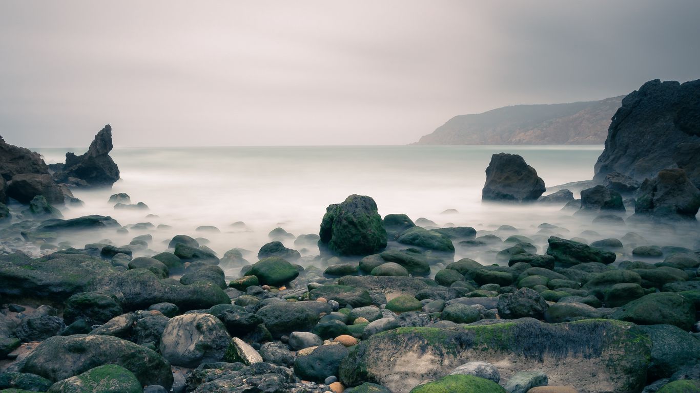 Download wallpaper 1366x768 stones, sea, fog tablet, laptop hd background