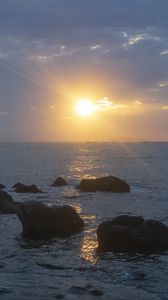 Preview wallpaper stones, sea, glare, sunset