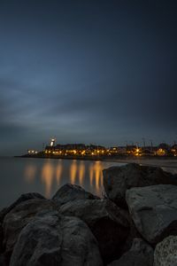 Preview wallpaper stones, sea, lighthouse, houses, lights