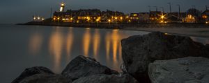 Preview wallpaper stones, sea, lighthouse, houses, lights