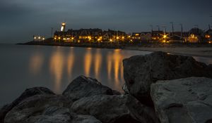 Preview wallpaper stones, sea, lighthouse, houses, lights