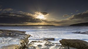 Preview wallpaper stones, sea, rays, horizon