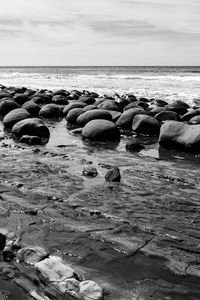 Preview wallpaper stones, sea, water, beach, horizon, bw