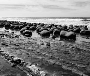Preview wallpaper stones, sea, water, beach, horizon, bw