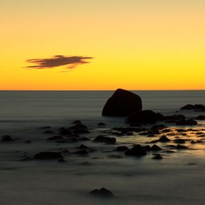 Preview wallpaper stones, sea, water, horizon, sunset