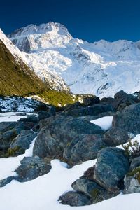 Preview wallpaper stones, snow, mountains, thawed patches, spring, light