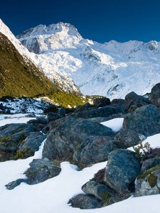 Preview wallpaper stones, snow, mountains, thawed patches, spring, light