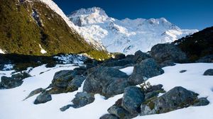 Preview wallpaper stones, snow, mountains, thawed patches, spring, light