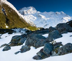 Preview wallpaper stones, snow, mountains, thawed patches, spring, light