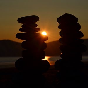 Preview wallpaper stones, stack, sun, sunset, dark