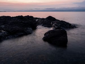 Preview wallpaper stones, water, sea, evening, horizon