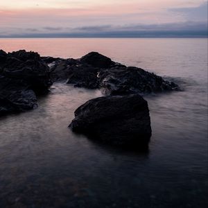 Preview wallpaper stones, water, sea, evening, horizon