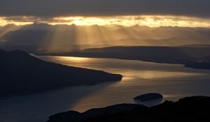 Preview wallpaper strait, coast, silhouettes, sunlight, dark