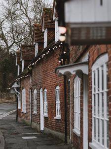 Preview wallpaper street, buildings, garlands, architecture, old, town