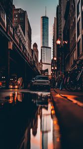 Preview wallpaper street, city, reflection, puddle, cars, buildings, bicycles