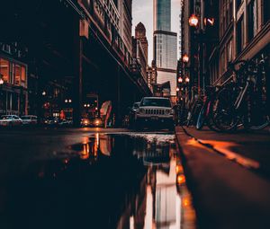 Preview wallpaper street, city, reflection, puddle, cars, buildings, bicycles