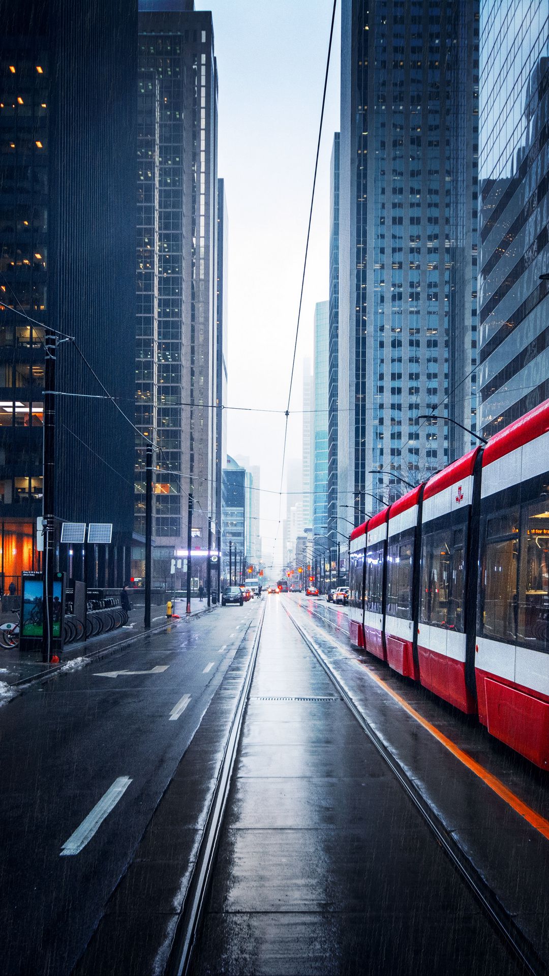 Download wallpaper 1080x1920 street, city, tram, buildings, rain