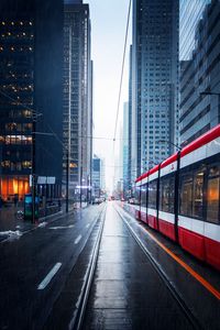 Preview wallpaper street, city, tram, buildings, rain