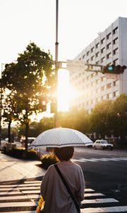 Preview wallpaper street, man, umbrella, sun, city