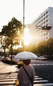 Preview wallpaper street, man, umbrella, sun, city