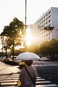 Preview wallpaper street, man, umbrella, sun, city