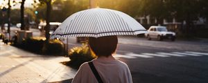 Preview wallpaper street, man, umbrella, sun, city