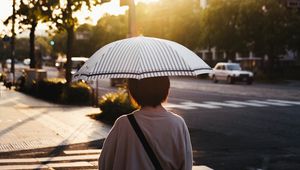 Preview wallpaper street, man, umbrella, sun, city