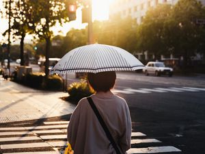 Preview wallpaper street, man, umbrella, sun, city